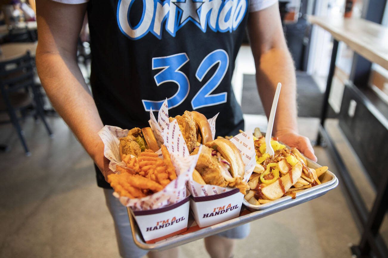 Tom Ceurvorst picks up his food order at Big Chicken on Thursday, Aug. 10, 2023 in Mukilteo, Washington. (Olivia Vanni / The Herald)