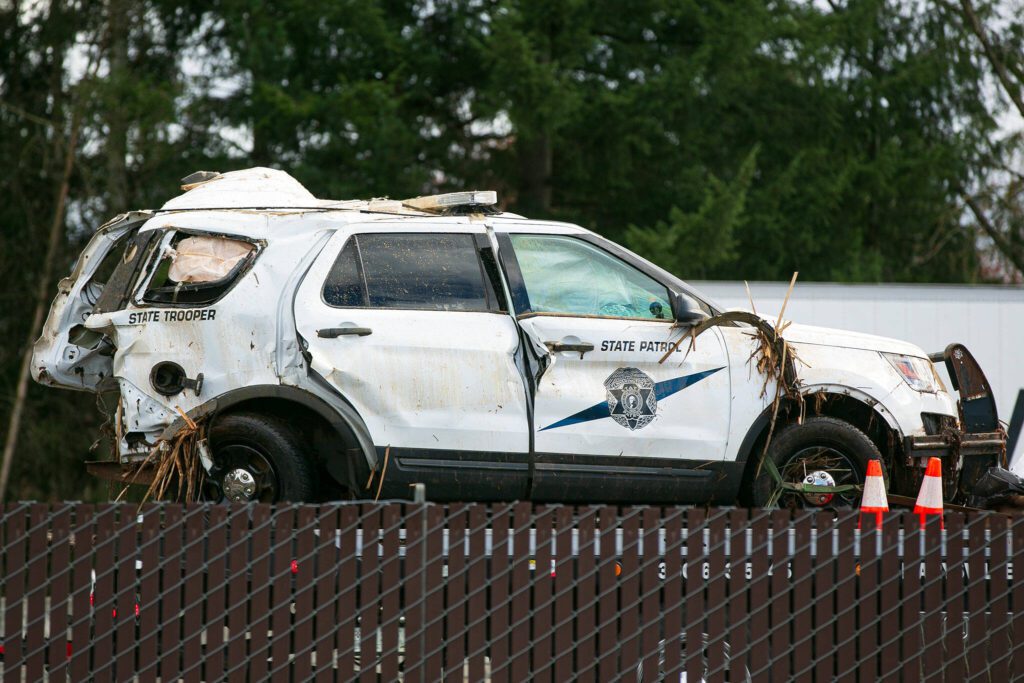 A heavily damaged Washington State Patrol vehicle is hauled away after a crash killed a trooper on southbound I-5 early Saturday, March 2, 2024, in Marysville, Washington. (Ryan Berry / The Herald)
