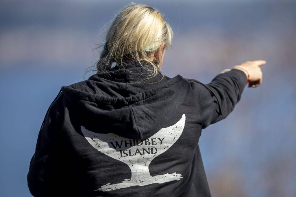 Cindi Rausch looks for whales on Monday, March 18, 2024 on Whidbey Island in Washington. (Annie Barker / The Herald)
