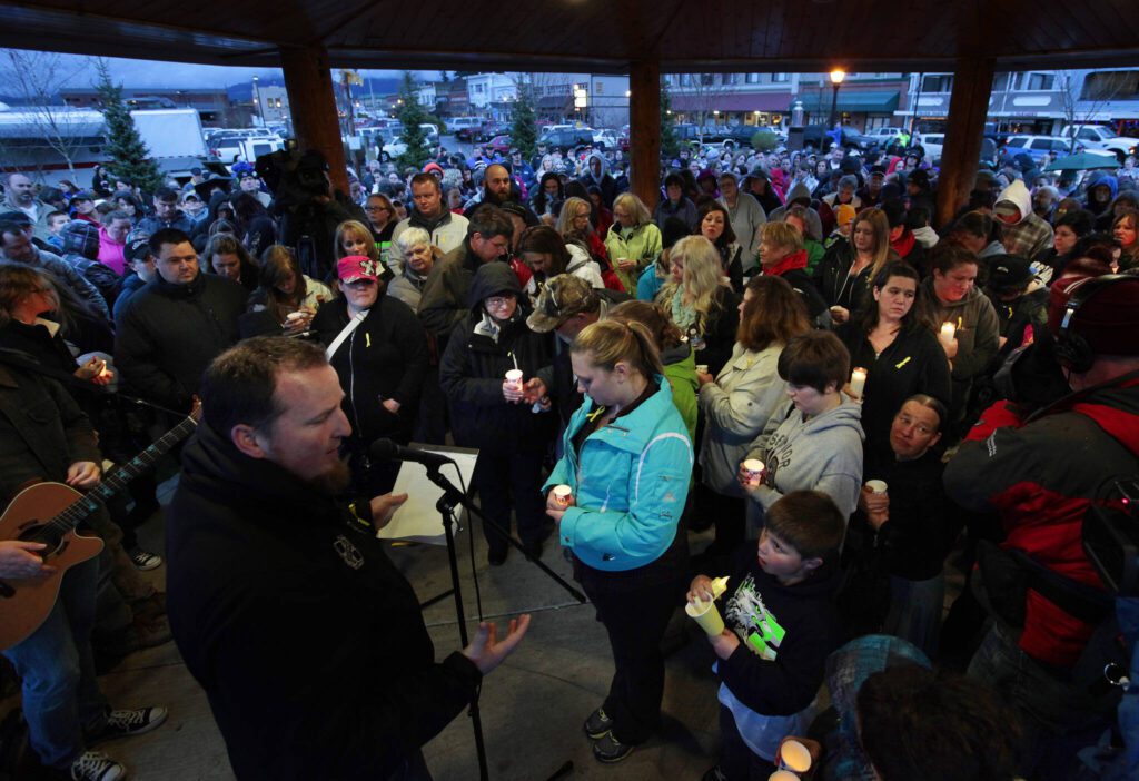 Attendees of a candlelight vigil at Legion Memorial Park in Arlington, Washington pray together on March 25, 2014. (Mark Mulligan / The Herald)
