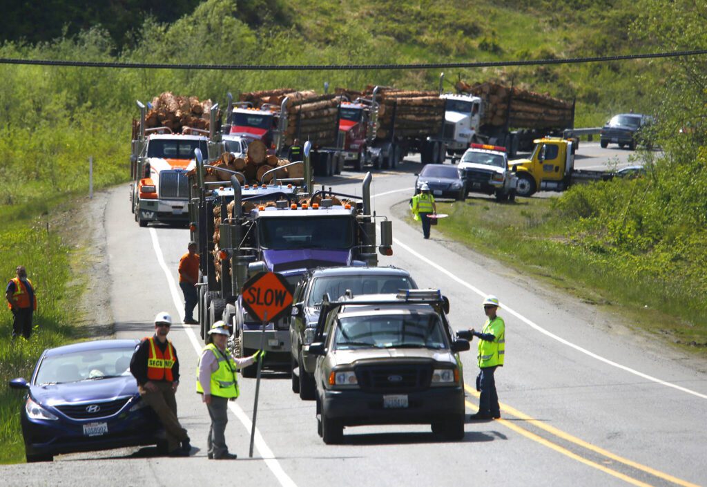 A line of vehicles line up eastbound on Highway 530 west of the mudslide waiting to take the service road bypass of 530 to Darrington, Washington on April 29, 2014. Locals called it “catching the ferry” as only one lane of traffic was let through the road at a time. The road was cut by loggers and other volunteers in the weeks following the slide. (Mark Mulligan / The Herald)

