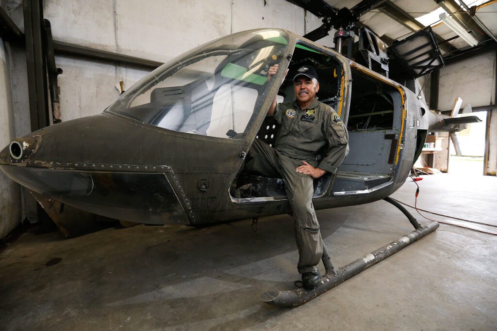 Snohomish County Sheriff’s Search and Rescue chief pilot Bill Quistorf sits in the stripped out body of Kiowa helicopter on Wednesday, April 19, 2017 in Snohomish, Wa. Search and Rescue is turning an old helicopter body into an outdoor-safety display for fairs and festivals. (Andy Bronson / The Herald)
