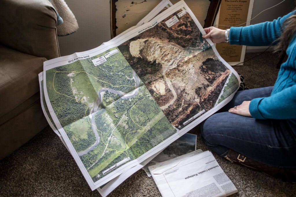 Julie Petersen shows information on the slide and items of her sister Christina Jefferds at her home on March 20, 2024 in Arlington, Washington. (Annie Barker / The Herald)
