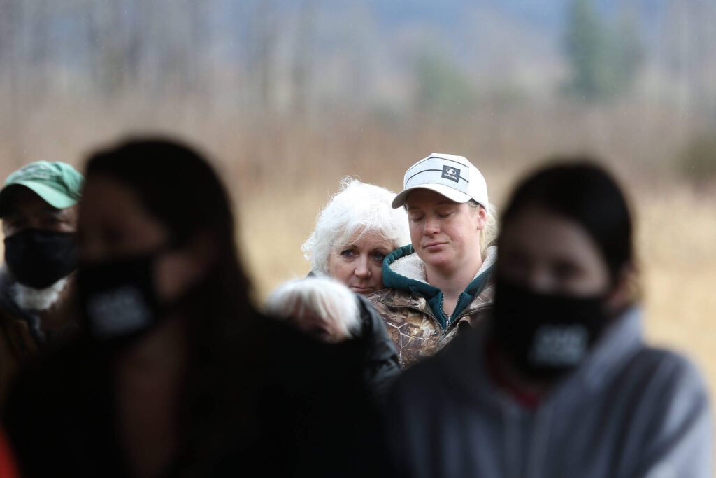 Diana Bejvl and her daughter Lisa hug as they listen to the names of family and friends killed in the Oso landslide at a memorial held in Oso Memorial Park on Monday, March 22, 2021 in Oso, Washington. Bejvl’s son Alan and his fiance Delaney Webb were killed in the slide. (Andy Bronson / The Herald)
