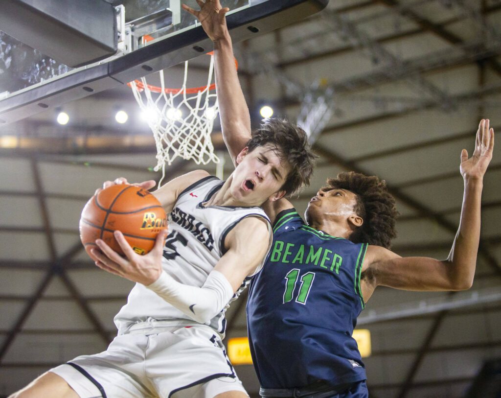 Mountlake Terrace’s Jaxon Dubiel grimaces after being fouled while attempting a layup during the 3A boys state basketball game against Todd Beamer on Feb. 28 in Tacoma. (Olivia Vanni / The Herald)
