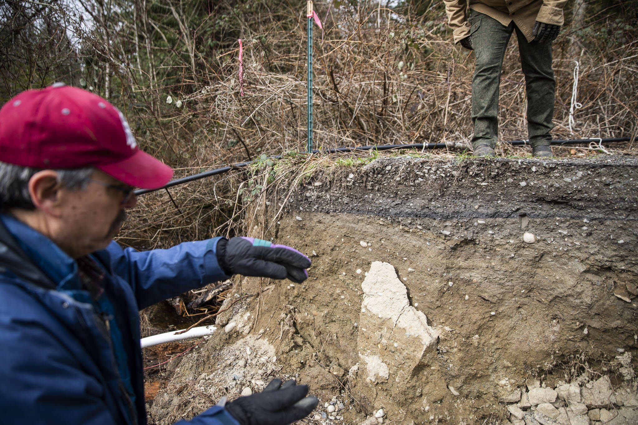 Steve Hall talks about how high the water reached when the road was washed out on Wednesday, March 6, 2024 in Marysville, Washington. (Olivia Vanni / The Herald)