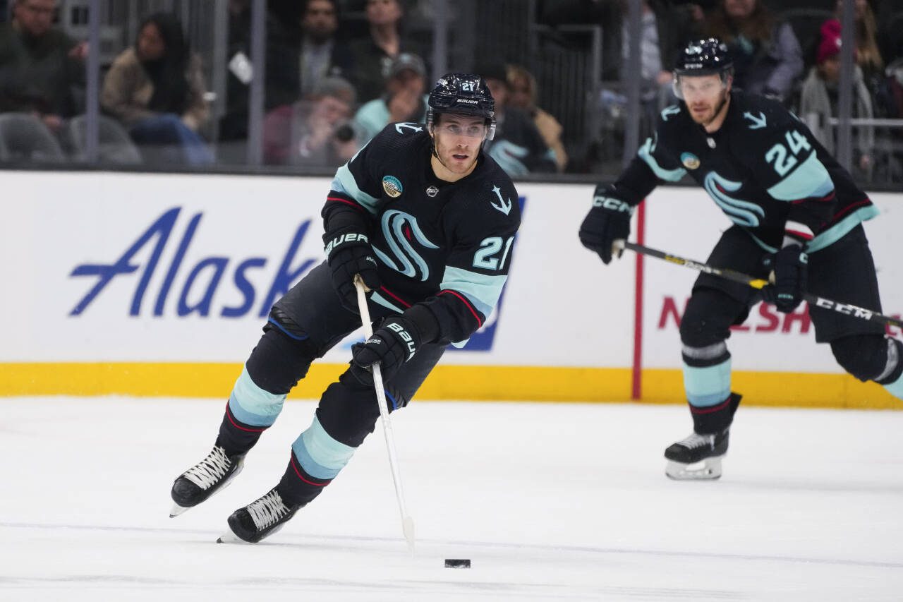 Seattle Kraken center Alex Wennberg (21) moves the puck against the Florida Panthers during a game Dec. 12, 2023, in Seattle. Wennberg was traded to the New York Rangers on Wednesday. (AP Photo/Lindsey Wasson)