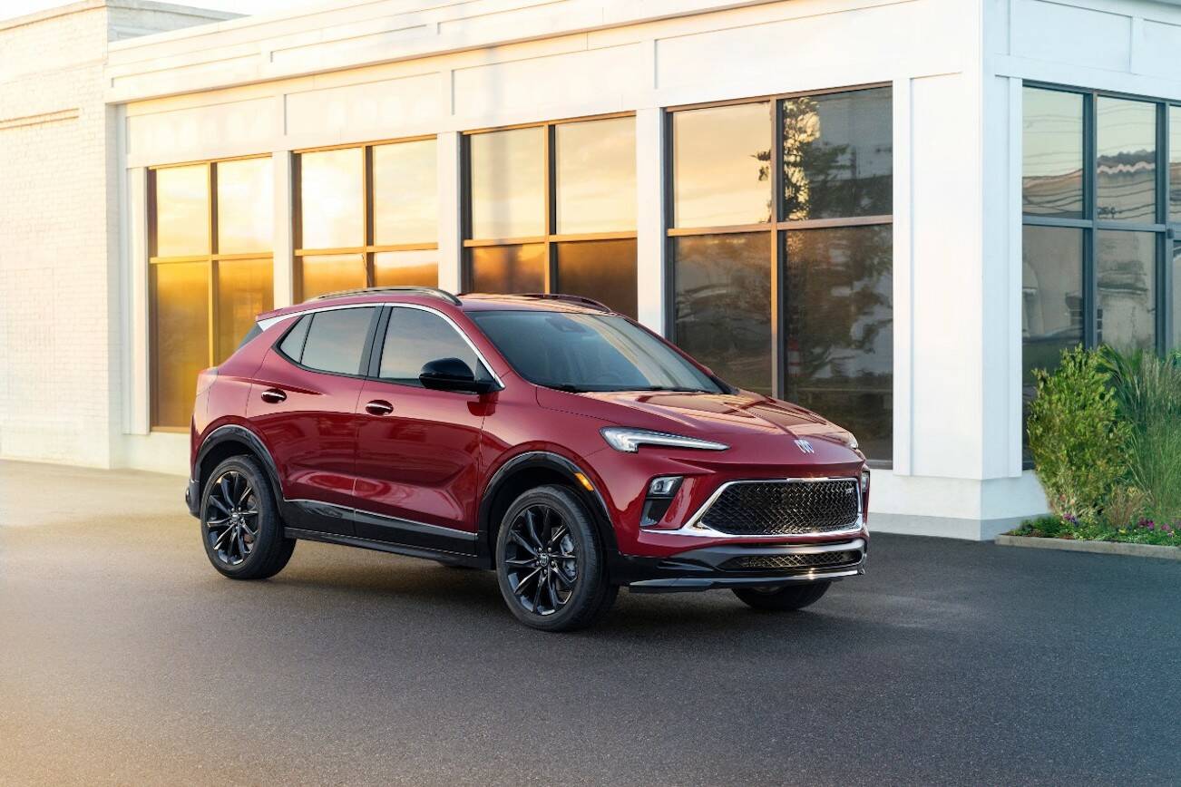 Front 3/4 view of the 2024 Buick Encore GX ST in Cinnabar Metallic. Preproduction model shown. Actual production model may vary. Available in Spring 2023. (Buick)