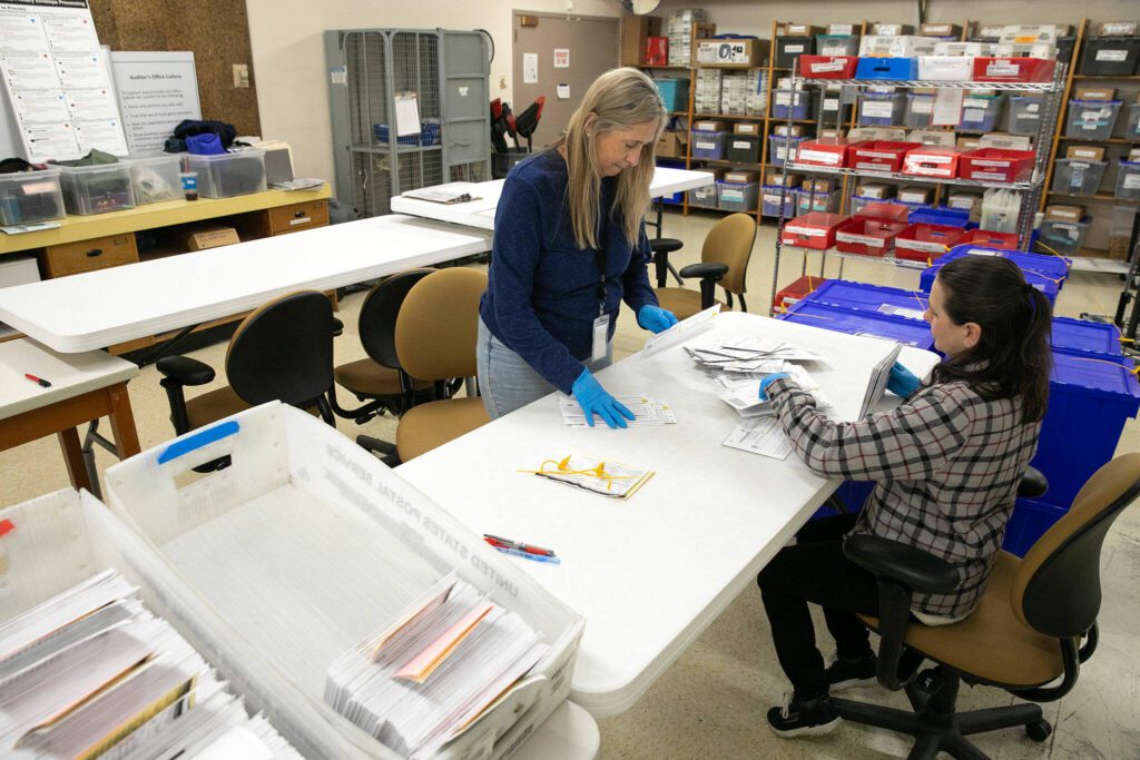 Election workers receive and sort ballots. “We’re running two concurrent elections: the Democratic primary and the Republican primary,” county Elections Manager Matthew Pangburn says. (Ryan Berry / The Herald)
