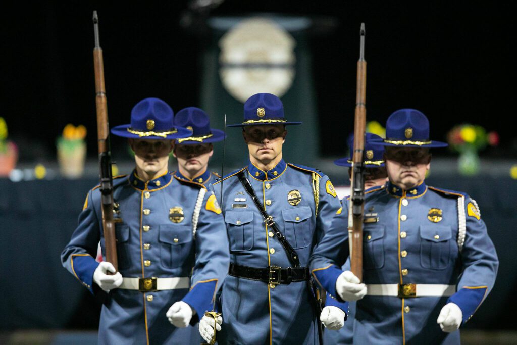 Washington State Patrol troopers perform a ceremony in honor of fellow trooper Chris Gadd on Tuesday, March 12, 2024, at Angel of the Winds Arena in Everett, Washington. (Ryan Berry / The Herald) 
