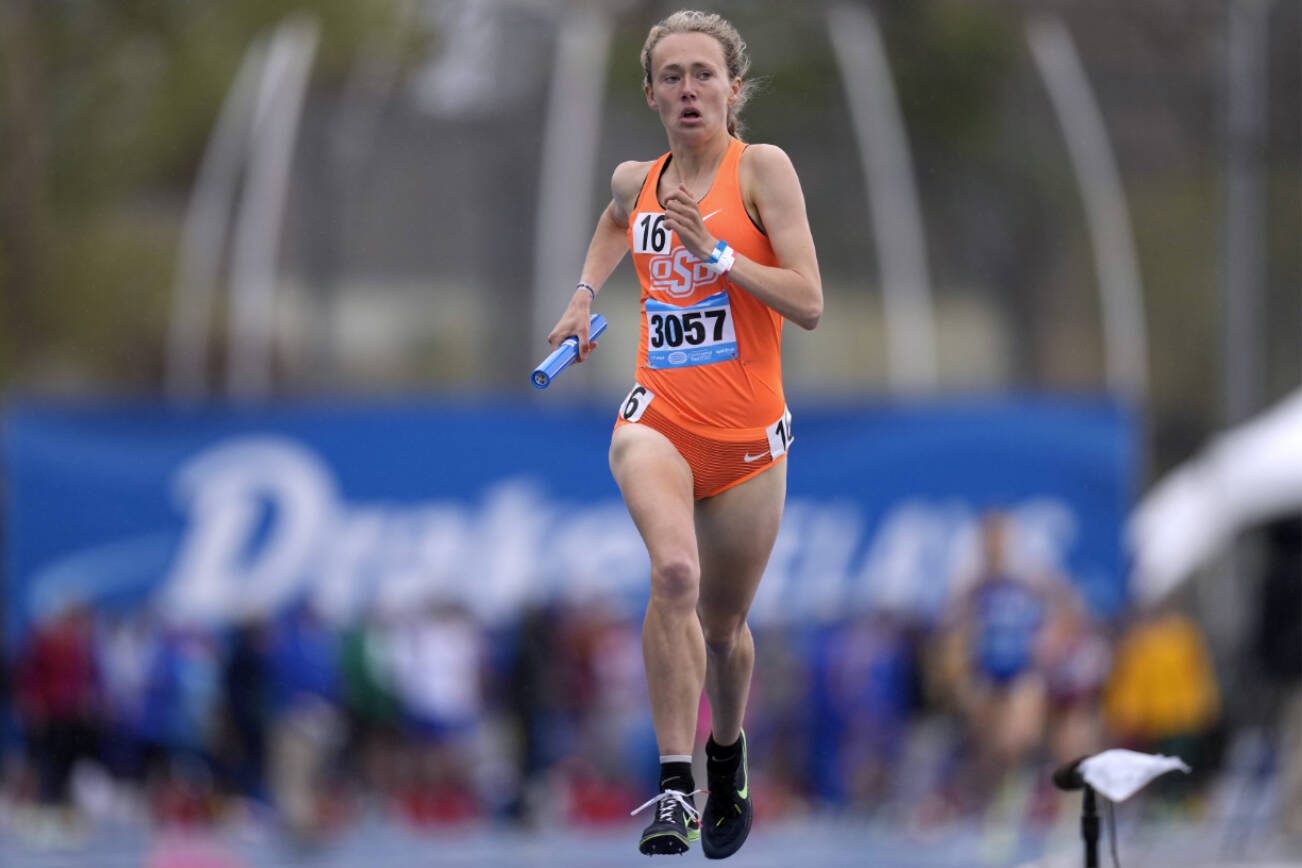 Oklahoma State's Taylor Roe anchors her team to victory in the women's distance medley relay at the Drake Relays athletics meet, Saturday, April 30, 2022, in Des Moines, Iowa. (AP Photo/Charlie Neibergall)