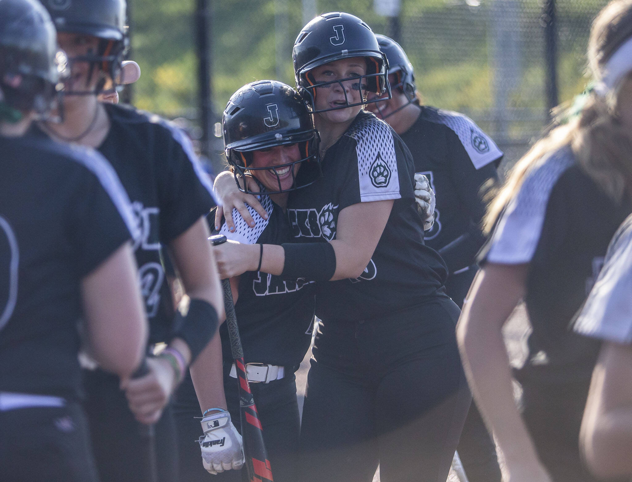 Jackson’s Rachel Sysum is hugged by Leneyah Mitchell after hitting a home run during the game against Bothell on May 19 in Everett. Jackson is the defending Class 4A state champion. (Olivia Vanni / The Herald)