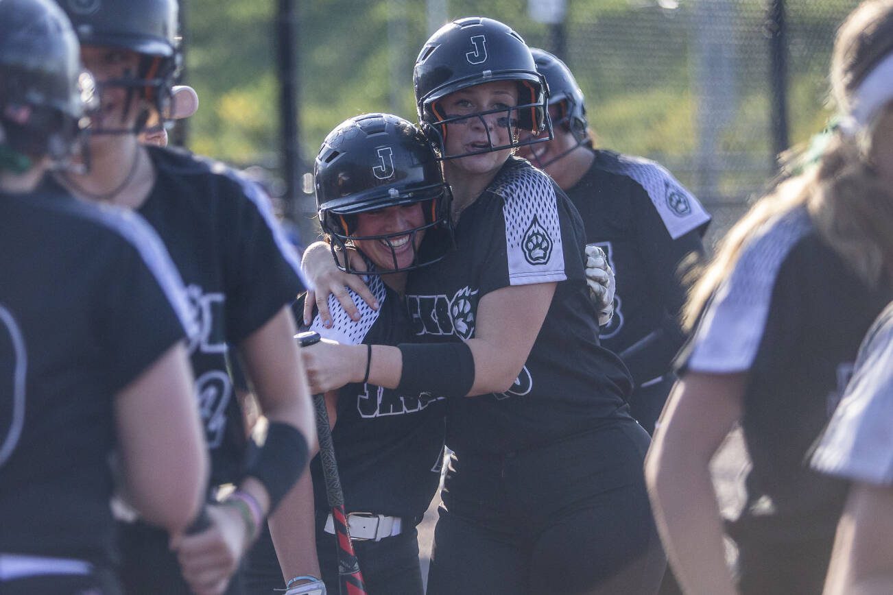 Jackson’s Rachel Sysum is hugged by Leneyah Mitchell after hitting a home run during the game against Bothell on Friday, May 19, 2023 in Everett, Washington. (Olivia Vanni / The Herald)