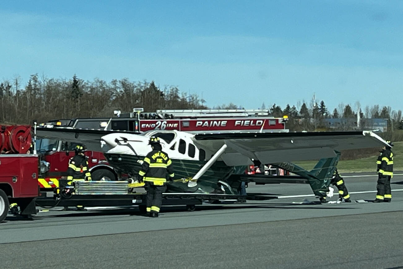 Paine Field firefighters load up a Cessna 337 Skymaster after a rough landing on the main runway Thursday at Paine Field. (Courtesy of Paine Field)