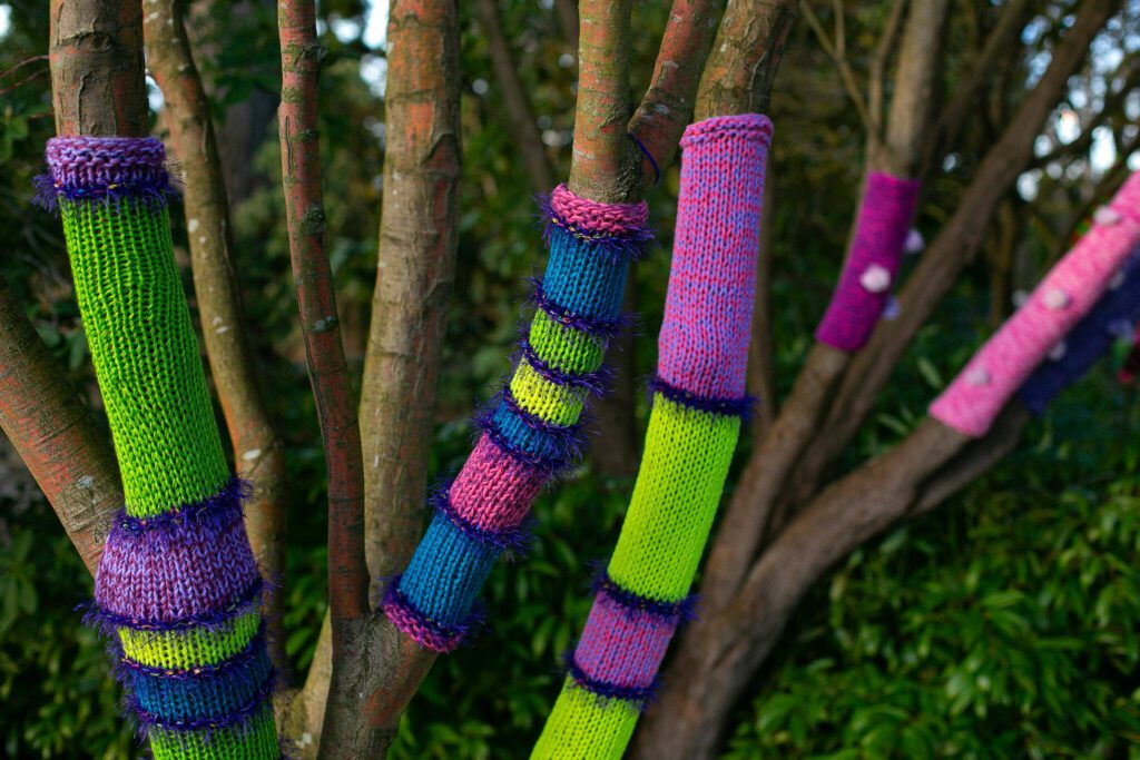 The branches of a tree are all wrapped in yarn as part of Color Storm at Evergreen Arboretum and Gardens on Thursday, March 14, 2024, in Everett, Washington. (Ryan Berry / The Herald)

