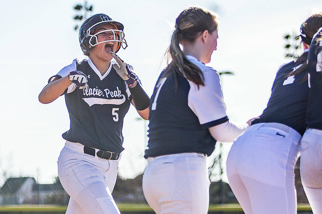 Glacier Peak’s Samantha Christensen runs to home plate to celebrate her home run with her teammates during the game against Snohomish on Friday, March 15, 2024 in Snohomish, Washington. (Olivia Vanni / The Herald)