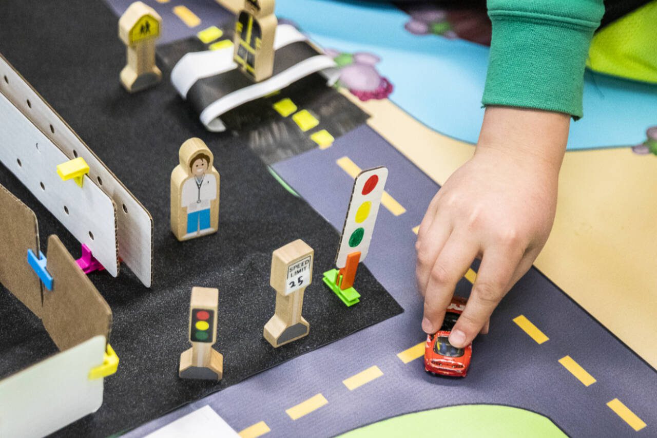 Students use a model or a city intersection to demonstrate their group’s traffic solutions at Hazelwood Elementary School on in March 2023 in Lynnwood. (Olivia Vanni / The Herald file photo)