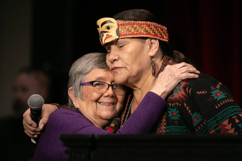 Tulalip Tribes Chair Teri Gobin, right, hugs Jeannie McCoy, wife of the late John McCoy, during a celebration on Tuesday, March 19, 2024, at Tulalip Casino’s Orca Ballroom in Tulalip, Washington. (Ryan Berry / The Herald)
