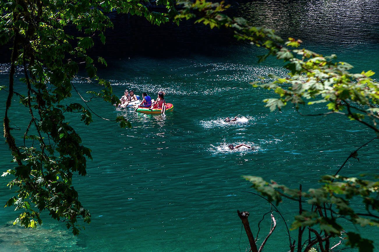 People float and swim at Eagle Falls on Wednesday, July 29, 2020 in Index, Washington. (Olivia Vanni / The Herald)