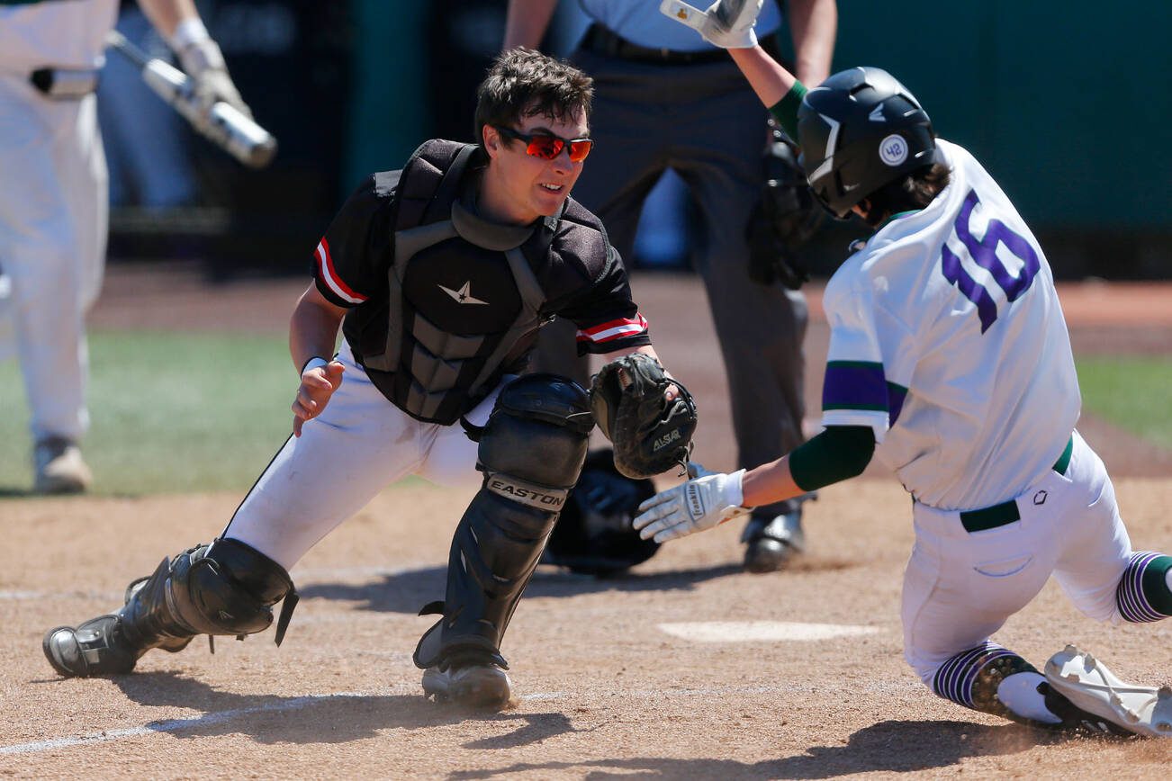 Mountlake Terrace’s Griffin Potter tags out a runner at home with the help of an outfield assist against Edmonds-Woodway in the 3A District title game on Saturday, May 13, 2023, at Funko Field in Everett, Washington. (Ryan Berry / The Herald)