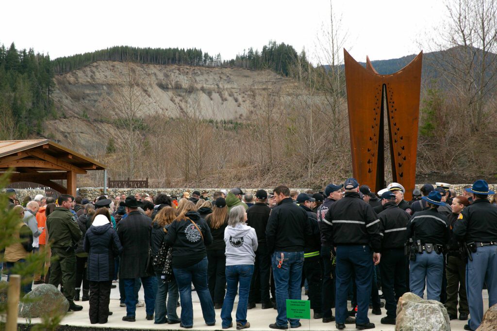 People begin to gather before the ten-year remembrance of the Oso landslide on Friday, March 22, 2024, at the Oso Landslide Memorial in Oso, Washington. (Ryan Berry / The Herald)
