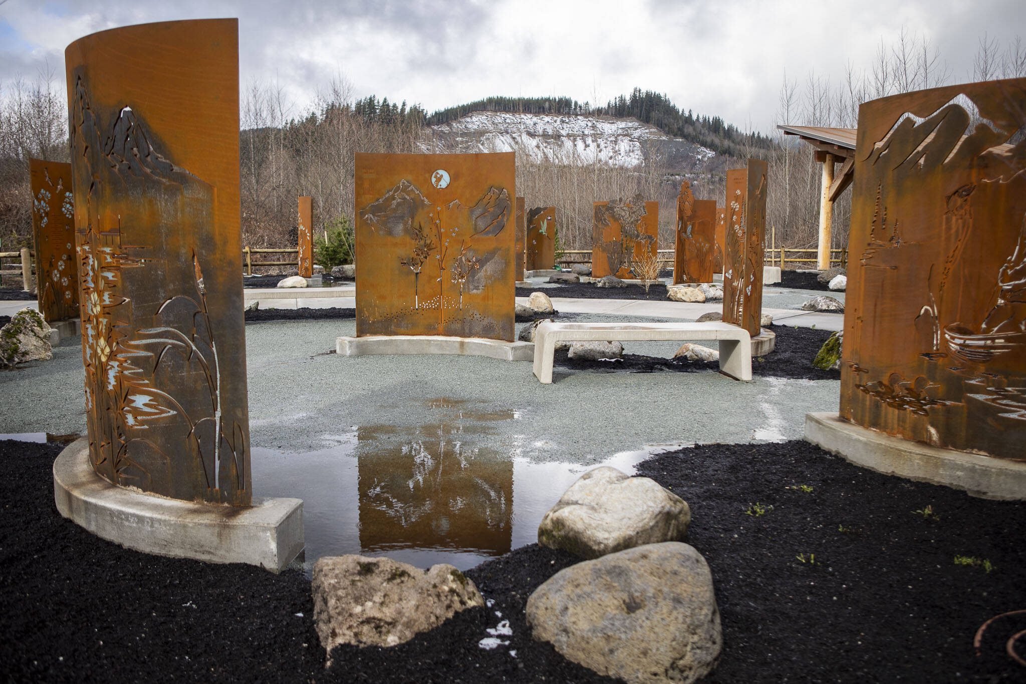 Custom-made tributes, honoring each of the 26 families lost in the mudslide, are displayed at the Oso Landslide Memorial on Monday, Feb. 26, 2024, near Oso, Washington. (Annie Barker / The Herald)
