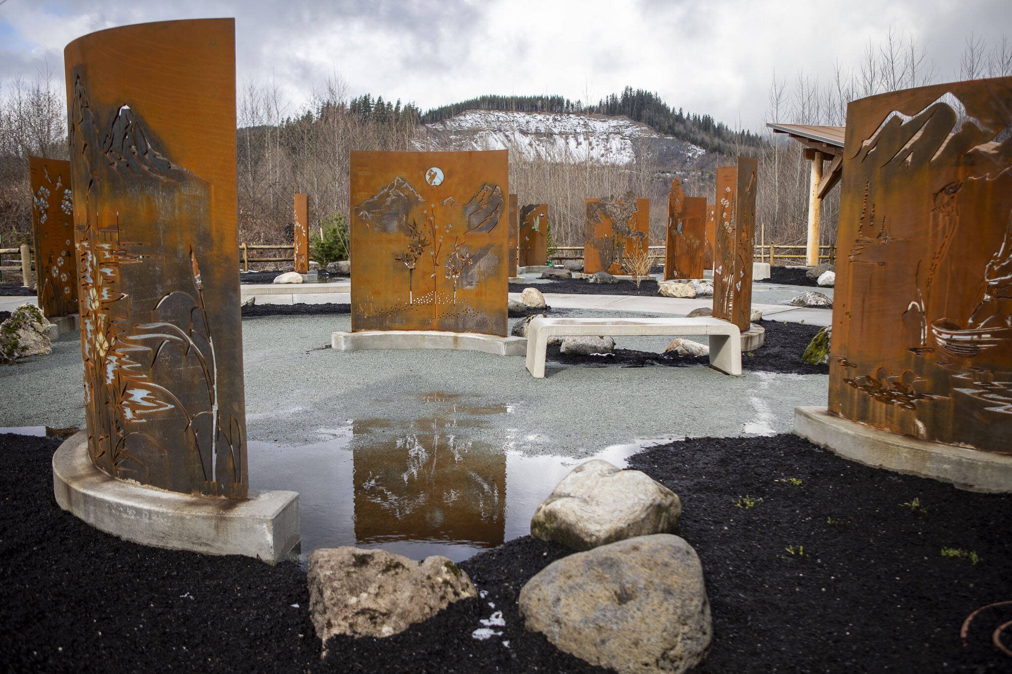 Custom-made tributes to families lost are displayed at the Oso Landslide Memorial on Monday, Feb. 26, 2024. (Annie Barker / The Herald)