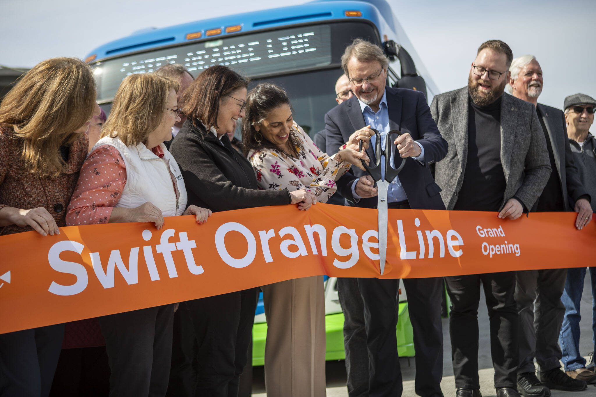 A ribbon is cut during the Orange Line kick off event at the Lynnwood Transit Center on Saturday, March 30, 2024 in Lynnwood, Washington. (Annie Barker / The Herald)