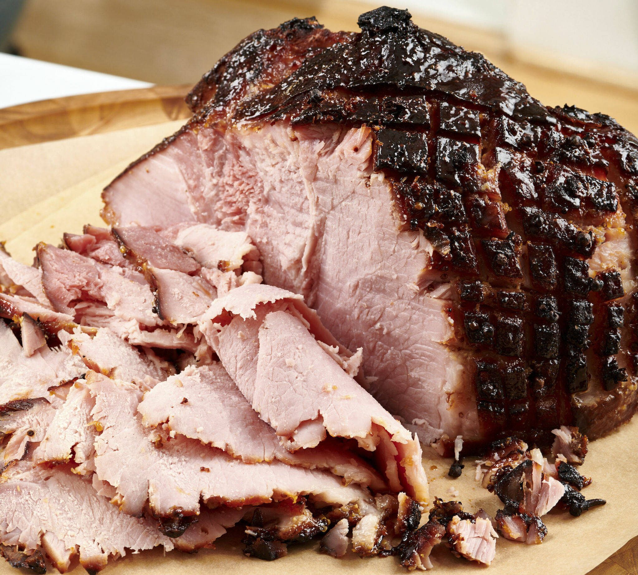 This September 2020 photo shows a sliced baked ham on parchment paper in Washington, D.C. Leftover ham, which will last for up to five days in the fridge, can be a springboard for other meals during the week. Of course you’ll want a sandwich or two, but there are many other ways to put that porky, smoky flavor to good use. (Cheyenne Cohen via AP)