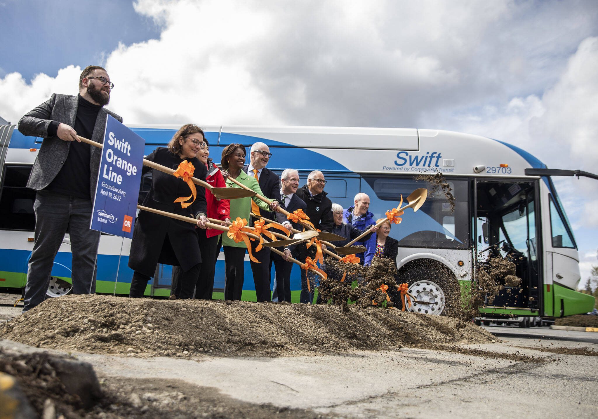 Washington legislators along with Gov. Jay Inslee and FTA Administrator Nuria Fernandez break ground at the Swift Orange Line’s Lynnwood City Center station in April 2022. The Orange Line service begins March 30. (Olivia Vanni / The Herald file photo)