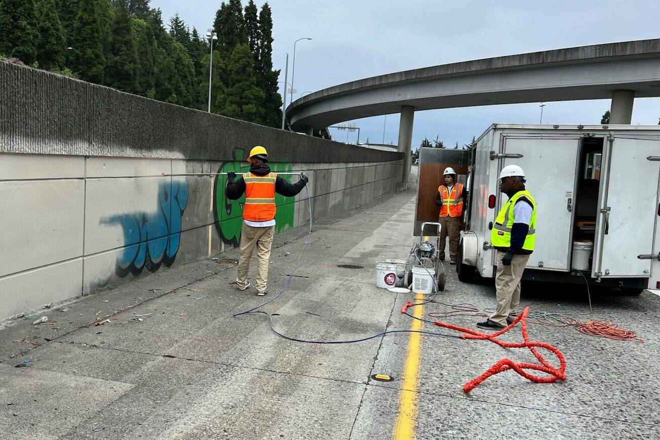 WSDOT contractors cover up graffiti during the 2021-2022 project on southbound I-5 from I-90 to Spokane Street in Seattle. (Washington State Department of Transportation)