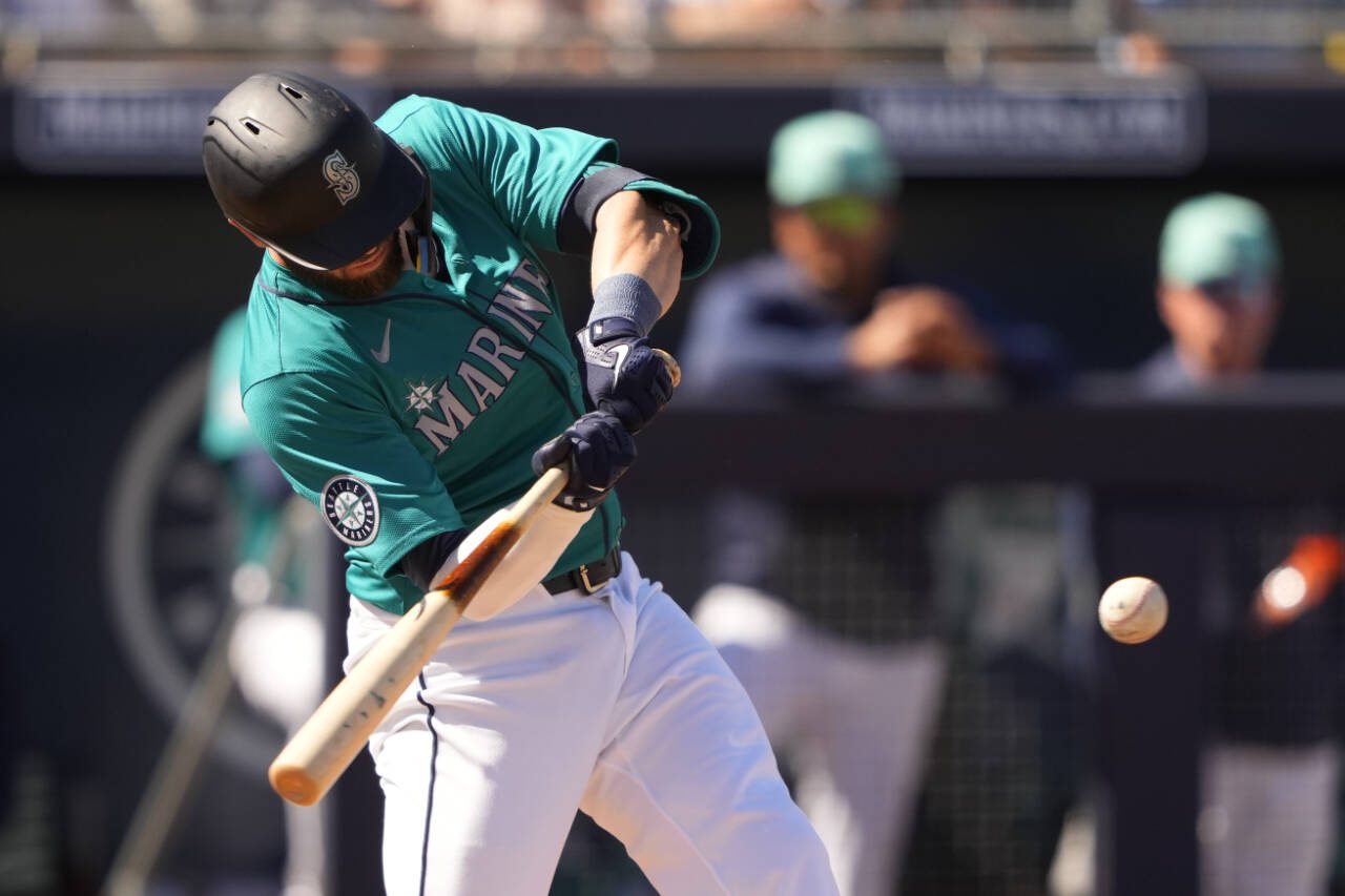Seattle Mariners’ Mitch Haniger hits a single against the San Diego Padres during the fourth inning of a spring training game March 11 in Peoria. (AP Photo/Lindsey Wasson)