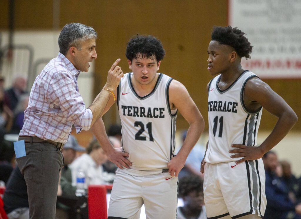 Mountlake Terrace head coach Nalin Sood (left) talks with Logan Tews (21) and Rayshaun Connor (11) during the Class 3A district semifinal game against Shorecrest on Feb. 13, 2024 in Marysville. (Olivia Vanni / The Herald)
