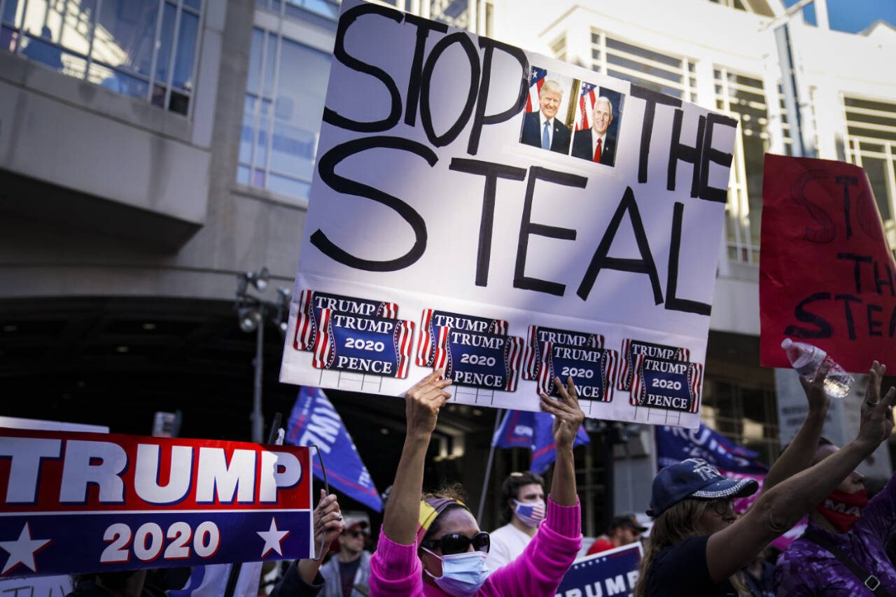 Supporters of President Donald Trump gather with signs claiming a stolen election outside the Philadelphia Convention Center as they await general election tabulation results, Friday, Nov. 6, 2020, in Philadelphia. (John Minchillo/ Associated Press file photo)