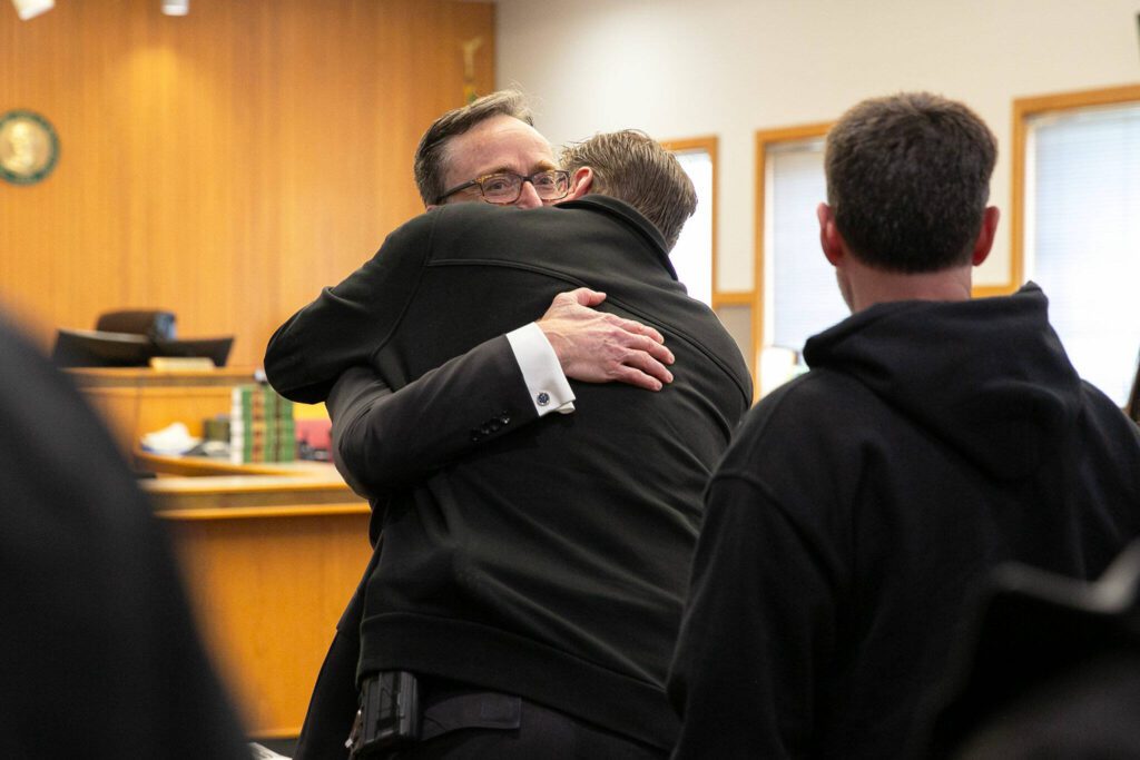 Deputy prosecutor Craig Matheson is hugged by a law enforcement officer following a guilty verdict in the trial of Alan Dean on Thursday, March 28, 2024, at Snohomish County Superior Court in Everett, Washington. (Ryan Berry / The Herald)
