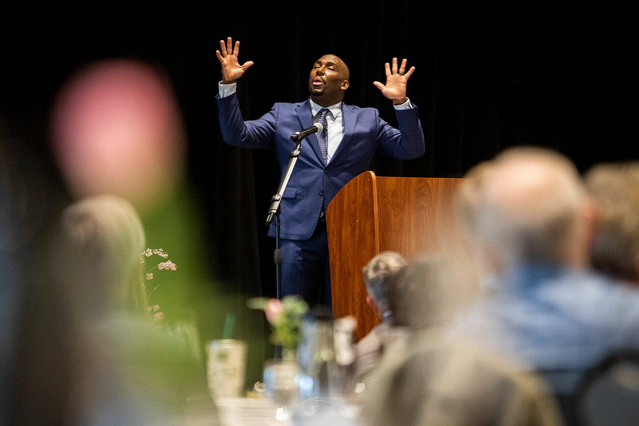 Chaplain Jonathan Rainey closes his eyes while speaking during the Snohomish County Prayer Breakfast on Friday, April 7, 2023 in Everett, Washington. (Olivia Vanni / The Herald)