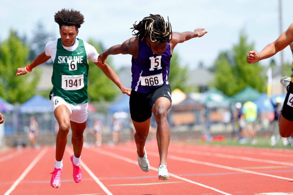 Kamiak T’Andre Waverly leans over the finish line while racing in the Class 4A boys 100-meter dash during the state track and field championships May 27, 2023, at Mount Tahoma High School in Tacoma. (Ryan Berry / The Herald)
