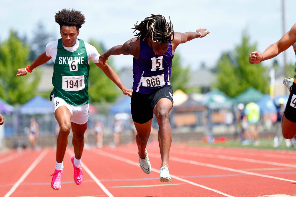 Kamiak T’Andre Waverly leans over the finish line while racing in the Class 4A boys 100-meter dash during the state track and field championships May 27, 2023, at Mount Tahoma High School in Tacoma. (Ryan Berry / The Herald)
