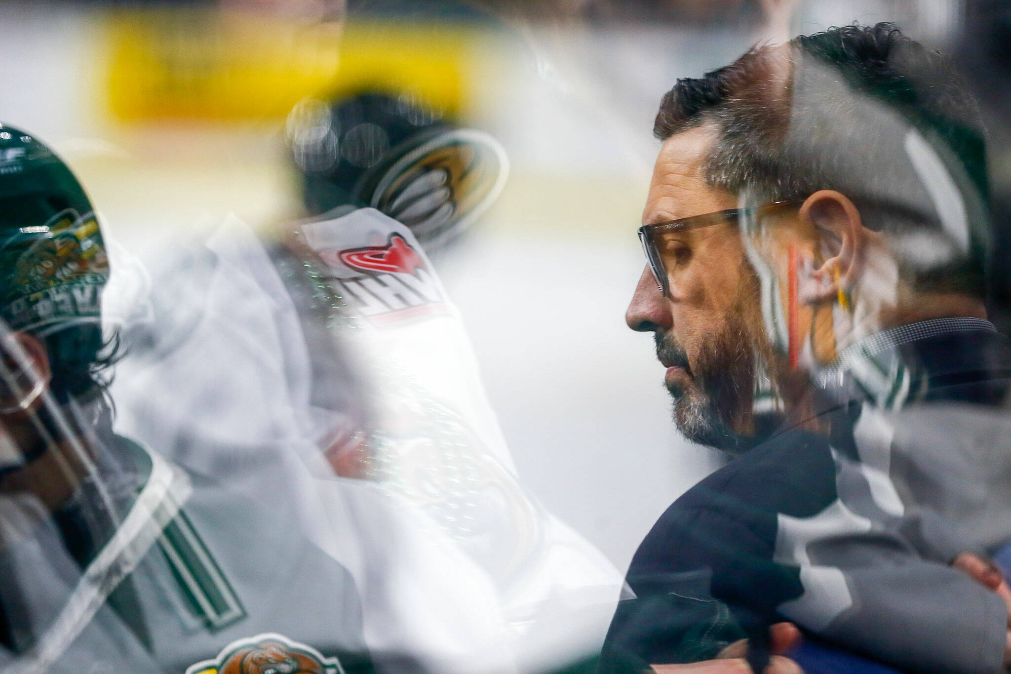 Everett Silvertips head coach and GM Dennis Williams stands behind the bench during his team’s playoff opener against the Vancouver Giants on Friday, March 29, 2024, at Angel of the Winds Arena in Everrett, Washington. (Ryan Berry / The Herald)