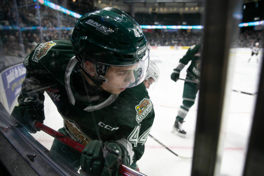 Everett Silvertips defender Parker Berge gets hit into the boards against the Vancouver Giants during the 2024 playoff opener on Friday, March 29, 2024, at Angel of the Winds Arena in Everrett, Washington. (Ryan Berry / The Herald)
