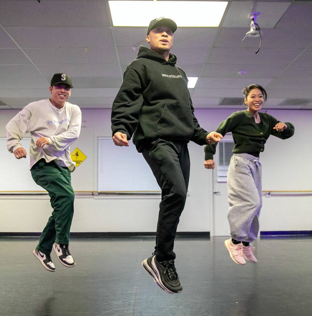 From left, Jon Kim, Pon Nuth and Lauren Mangibin take to the air while working on a new sequence during a RTHMZ rehearsal in Lynnwood. (Ryan Berry / The Herald)
