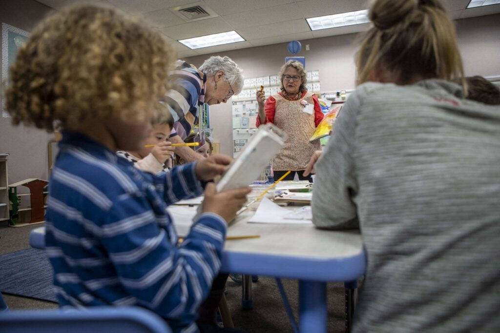 Bobbi Samples leads a painting exercise during the “Afternoon of the Arts” program, where students spend part of the day on an art project at Utsalady Elementary on March 22, 2024 in Camano, Washington. (Annie Barker / The Herald)
