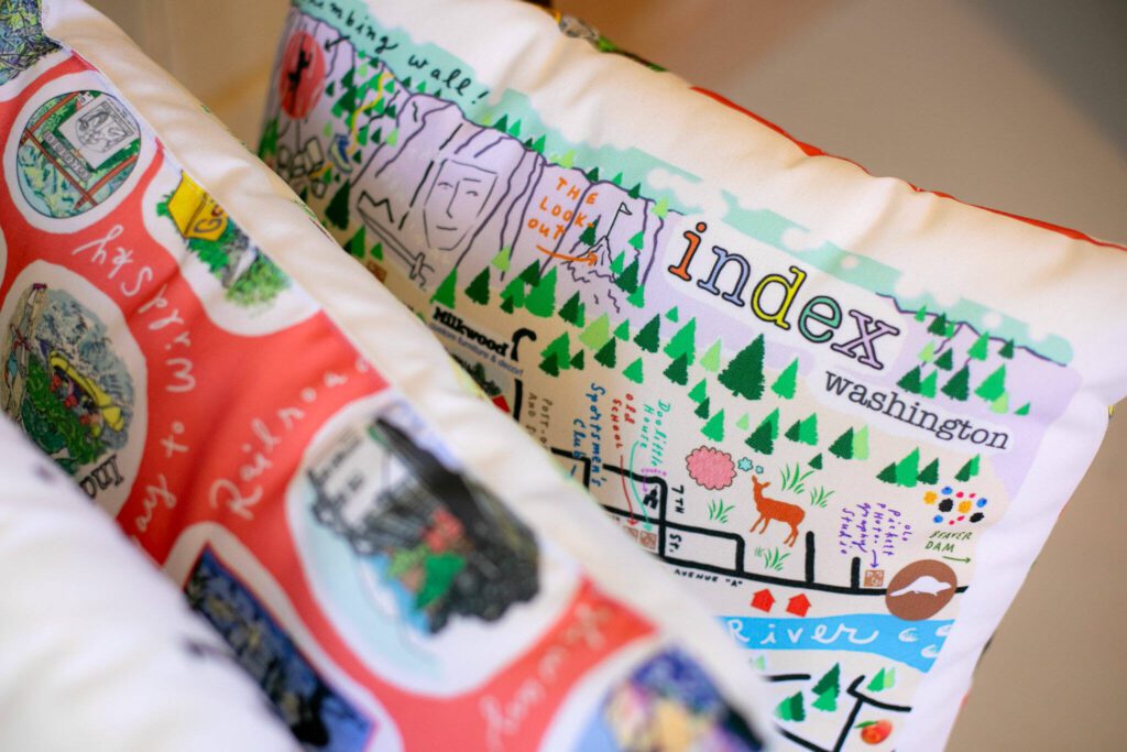 A number of pillows designed by Frances Peterson are sold at Milkwood on Sunday, March 31, 2024, in Index, Washington. (Ryan Berry / The Herald)
