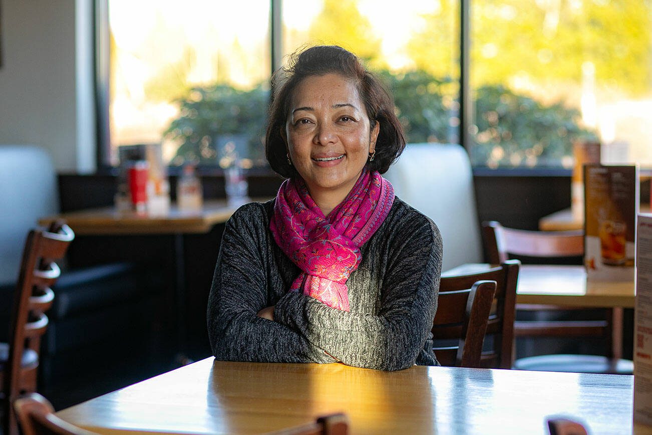 Binita Shrestha, new co-owner of Boston’s Restaurant & Sports Bar, sits in her restaurant on Monday, March 18, 2024, in Smokey Point, Washington. (Ryan Berry / The Herald)