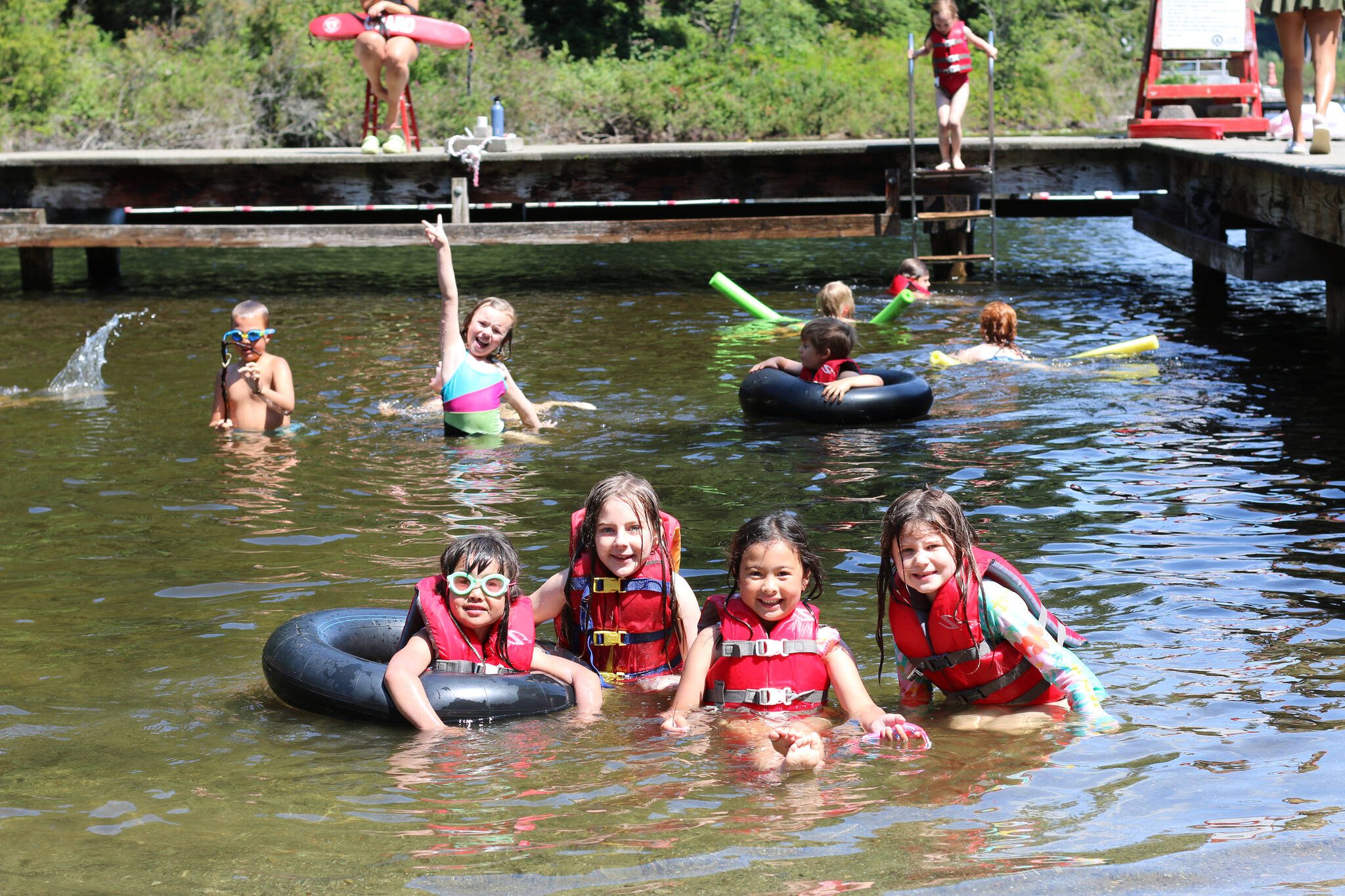 Campers pose in lifejackets while playing in the water. Scholarships allowed 97 campers to attended Camp Fire last year. (Photo courtesy by Camp Fire)