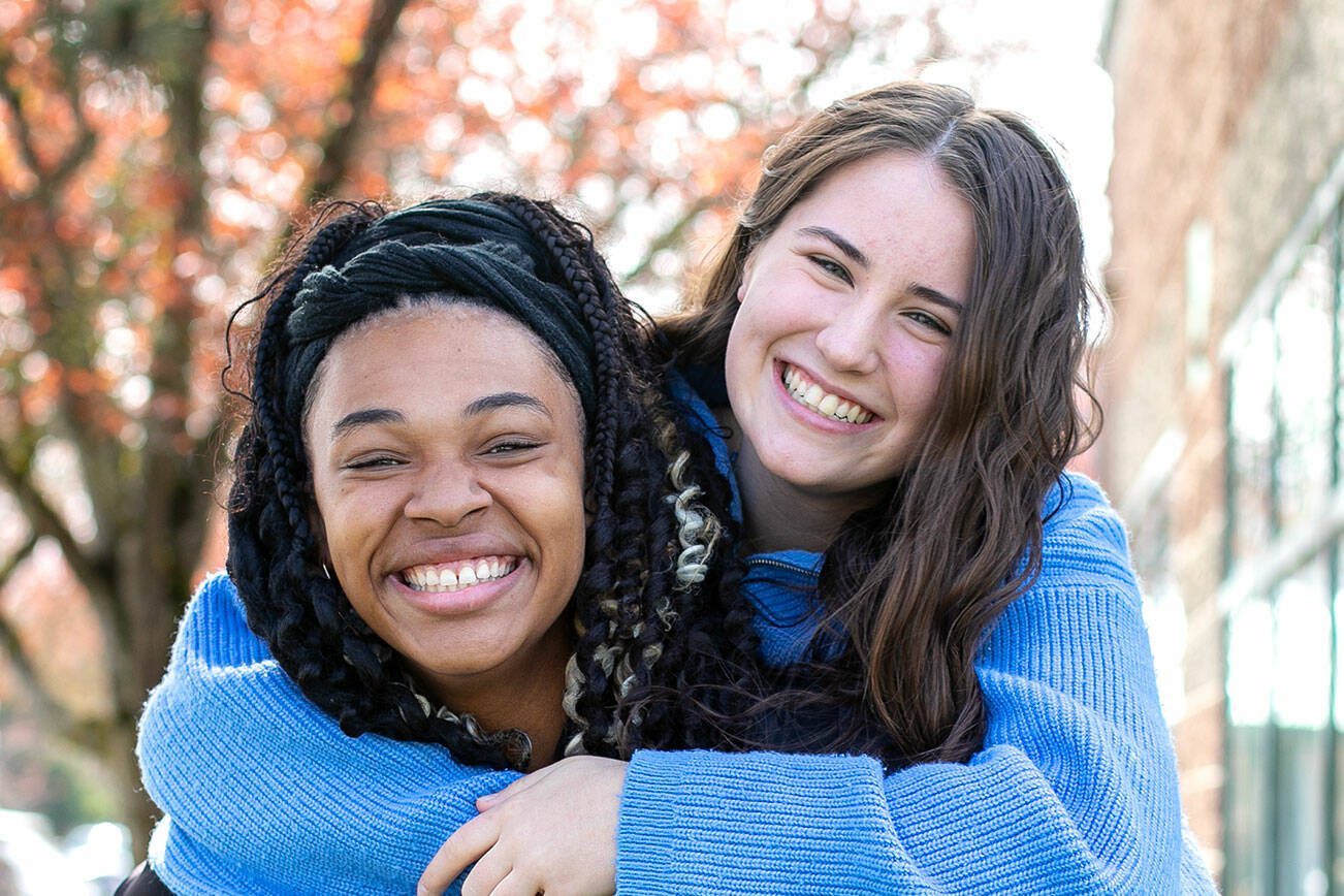 Gianna Frank gives a piggy-back ride to best friend Claire Michal on Monday, April 1, 2024, outside the YMCA in Marysville, Washington. The Marysville School District seniors have each attended the U.S. Senate Youth Program — Michal last year and Frank this year — becoming the first tandem in program history to represent the same school district in consecutive years. (Ryan Berry / The Herald)