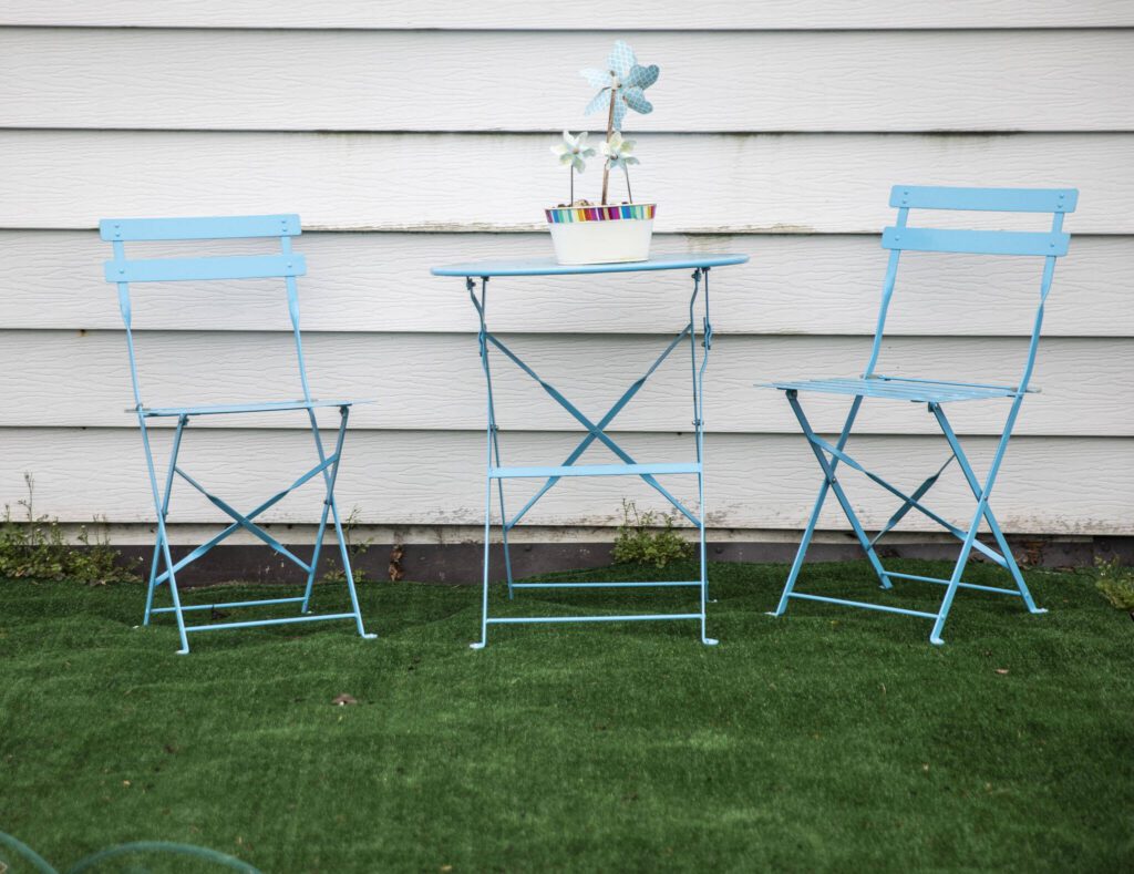 Blue outdoor furniture and pinwheels are visible outside of one of the homes in Royalwood Estates Mobile Home Park on Monday, March 11, 2024 in Lynnwood, Washington. (Olivia Vanni / The Herald)
