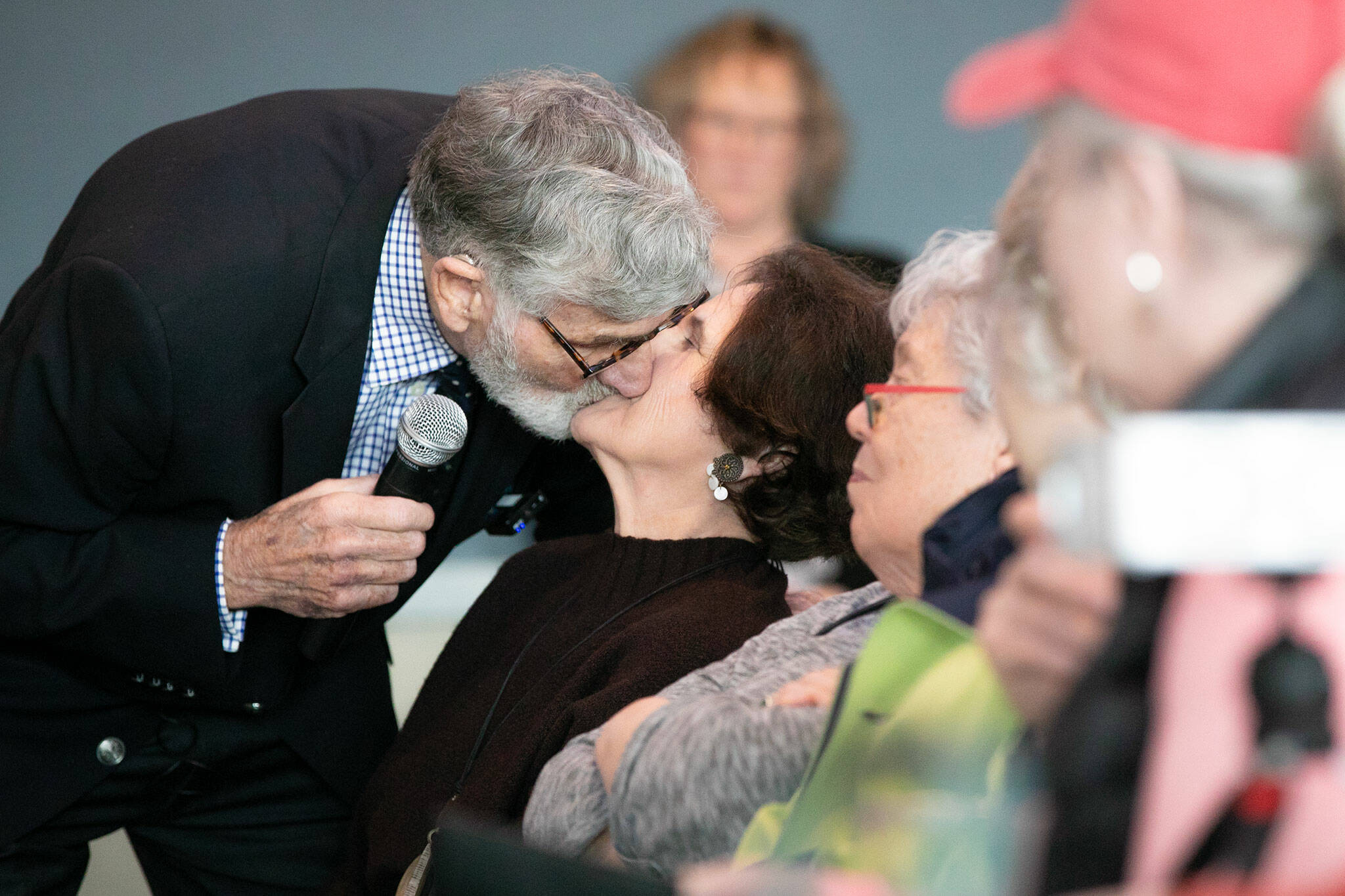 Graham Kerr, 90, leans down and kisses his new wife, Nancy, during Senior Expo on Tuesday, March 26, 2024, at Hotel Indigo in Everett, Washington. (Ryan Berry / The Herald)