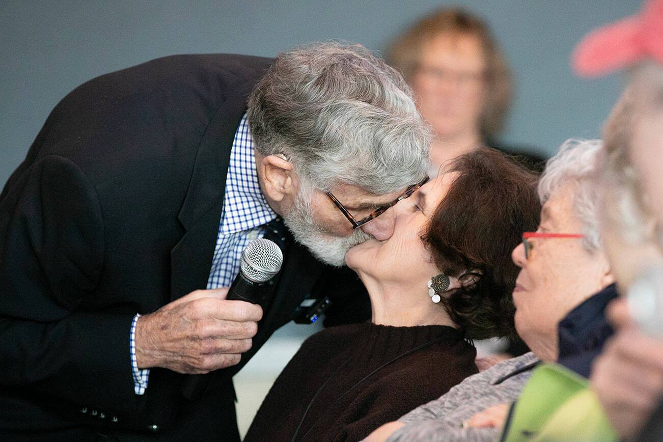 Graham Kerr, 90, leans down and kisses his new wife, Nancy, during Senior Expo on Tuesday, March 26, 2024, at Hotel Indigo in Everett, Washington. (Ryan Berry / The Herald)