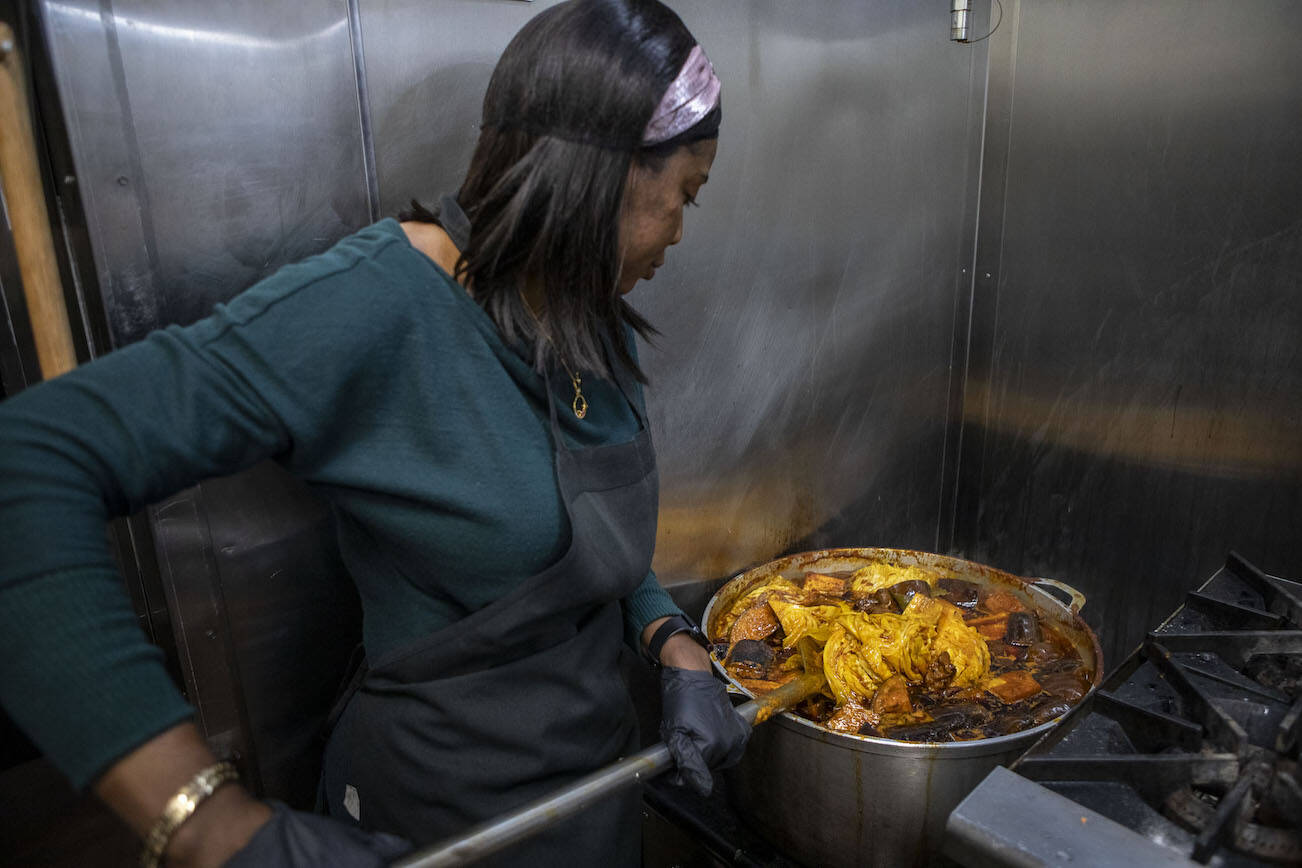 Owner Fatou Dibba prepares food at the African Heritage Restaurant on Saturday, April 6, 2024 in Everett, Washington. (Annie Barker / The Herald)